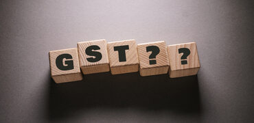 GST Word Written on Wooden Cubes